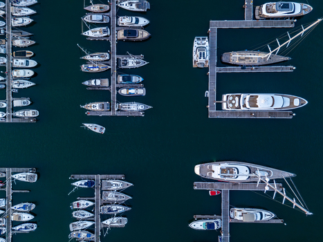 Aerial view of Marina de Cascais with numerous yachts and sailboats moored at the docks in the calm blue water of the Atlantic Ocean. Cascais Lisboa Portugal. Aerial view of Marina de Cascais with numerous yachts and sailboats moored at the docks in the calm blue water of the Atlantic Ocean. Cascais Lisboa Portugal.