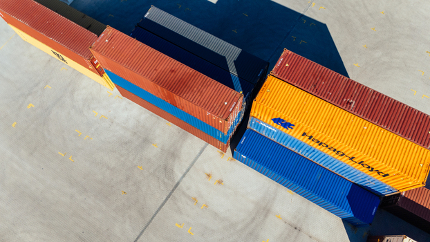 Indjija Serbia 24 August 2026 Aerial view of colorful shipping containers arranged on a concrete terminal surface.