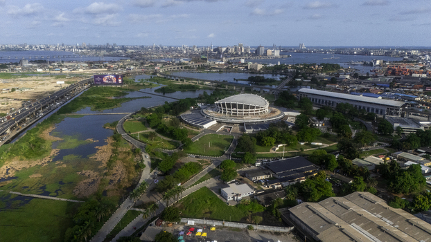 Aerial view of the Wole Soyinka Centre for Culture and Creative Arts National Theatre Nigeria surrounded by lush greenery and the city skyline in Lagos Lagos Nigeria. Aerial view of the Wole Soyinka Centre for Culture and Creative Arts National Theatre Nigeria surrounded by lush greenery and the city skyline in Lagos Lagos Nigeria.