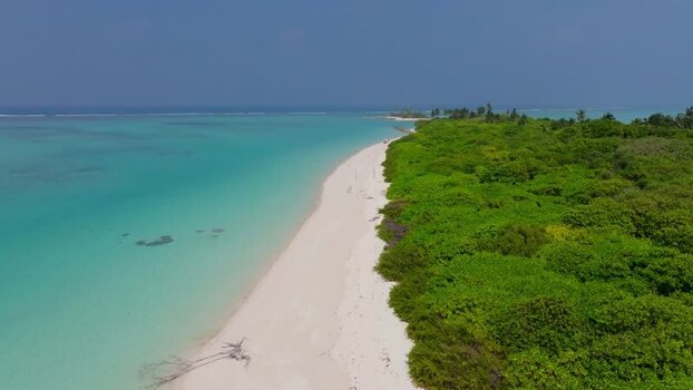 Aerial view of small island with turquoise waters Maldives.