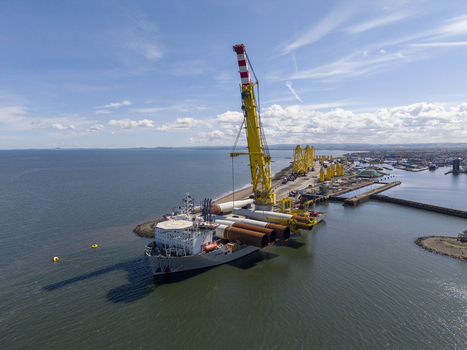 Edinburgh United Kingdom 06 May 2026 Aerial view of Leith Docks featuring a large crane ship loaded with industrial components under a bright blue sky. Edinburgh United Kingdom 06 May 2026 Aerial view of Leith Docks featuring a large crane ship loaded with industrial components under a bright blue sky.