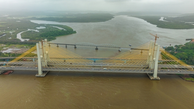 Aerial view of the Zuari Bridge spanning the river with cable stayed architecture and surrounding lush green landscape in Cortalim Goa India.
