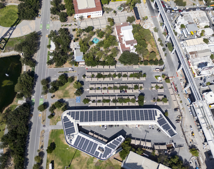 Aerial view of the solar panel covered roof of a modern building within Fundidora Park featuring a parking lot lush green spaces and urban infrastructure in Monterrey Nuevo Leon Mexico. Aerial view of the solar panel covered roof of a modern building within Fundidora Park featuring a parking lot lush green spaces and urban infrastructure in Monterrey Nuevo Leon Mexico.