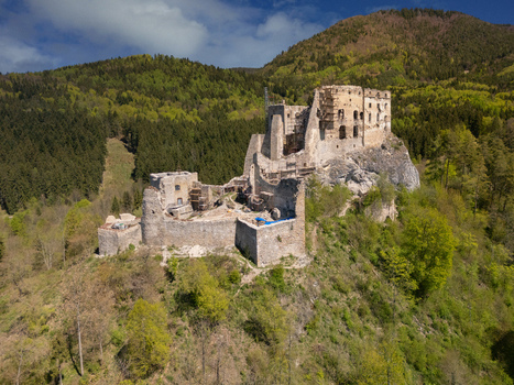 Aerial view of the medieval Castle Likava ruins on a rocky hilltop surrounded by dense green forests Likavka Zilina Region Slovakia. Aerial view of the medieval Castle Likava ruins on a rocky hilltop surrounded by dense green forests Likavka Zilina Region Slovakia.