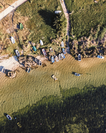 Aerial view of fishing boat anchored along the south Portuguese coastline near Lagoa de Albufeira in Sesimbra Municipality Setubal Portugal.