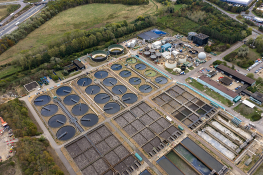 Aerial view of the water treatment plant with circular sedimentation tanks and rectangular filtration basins in Broughton England United Kingdom. Aerial view of the water treatment plant with circular sedimentation tanks and rectangular filtration basins in Broughton England United Kingdom.