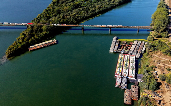 Aerial view of Smederevo bridge and shipyard with cargo barges docked along the riverbank in Smederevo Podunavlje District Serbia.