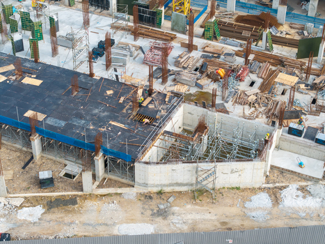 Bukit Tambun Malaysia 25 September 2026 Aerial view of a construction site featuring concrete foundations scaffolding steel reinforcement bars and workers. Bukit Tambun Malaysia 25 September 2026 Aerial view of a construction site featuring concrete foundations scaffolding steel reinforcement bars and workers.