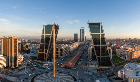 Aerial view of the iconic Puerta de Europa towers at Plaza Castilla featuring leaning skyscrapers urban architecture and busy streets in Madrid Comunidad de Madrid Spain.