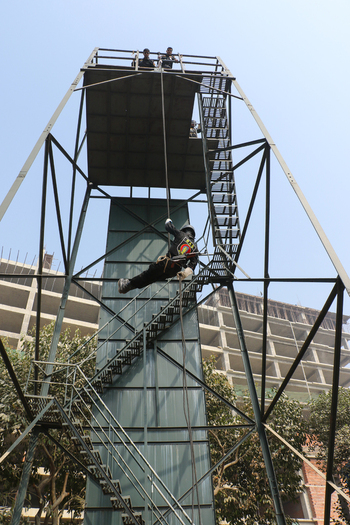 Dhaka Bangladesh 06 January 2017 View of a Rapid Action Battalion officer rappelling down a metal training tower at the RAB Headquarters during a demonstration. Dhaka Bangladesh 06 January 2017 View of a Rapid Action Battalion officer rappelling down a metal training tower at the RAB Headquarters during a demonstration.