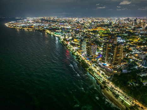 Aerial view of the illuminated Santo Domingo Malecon coastline at night featuring high rise buildings city lights and the Caribbean Sea in Santo Domingo Distrito Nacional Dominican Republic. Aerial view of the illuminated Santo Domingo Malecon coastline at night featuring high rise buildings city lights and the Caribbean Sea in Santo Domingo Distrito Nacional Dominican Republic.