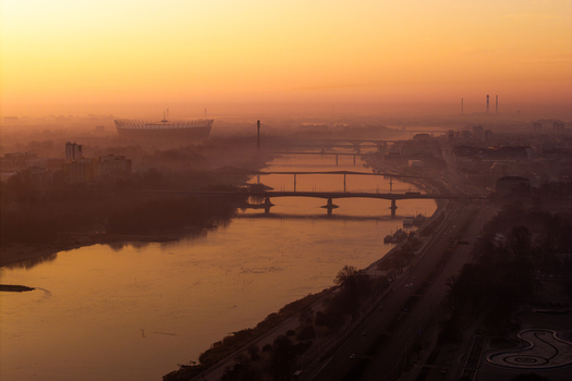 Warsaw Poland 08 March 2025 Aerial view of the Vistula River at sunset featuring multiple bridges the National Stadium in the distance and a warm golden glow over the urban landscape. Warsaw Poland 08 March 2025 Aerial view of the Vistula River at sunset featuring multiple bridges the National Stadium in the distance and a warm golden glow over the urban landscape.