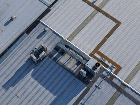 Melbourne Australia 22 September 2026 Aerial view of industrial factory rooftops in Kilsyth featuring metal corrugated surfaces ventilation units and long shadows. Melbourne Australia 22 September 2026 Aerial view of industrial factory rooftops in Kilsyth featuring metal corrugated surfaces ventilation units and long shadows.