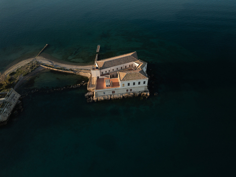 Aerial view of the historic Torre Avalos fortification surrounded by deep blue sea water during golden hour in Augusta Sicily Italy. Aerial view of the historic Torre Avalos fortification surrounded by deep blue sea water during golden hour in Augusta Sicily Italy.