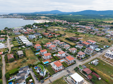 Aerial view of modern villas with private swimming pools and red tiled roofs situated along the Black Sea coastline in Lozenets Burgas Bulgaria.