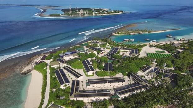 Aerial view of a tropical island resort with solar panels Maldives. Aerial view of a tropical island resort with solar panels Maldives.