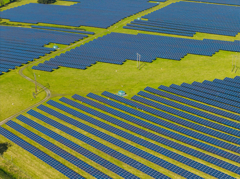 Aerial view of a large solar farm with rows of photovoltaic panels installed on green fields in Lisburn Northern Ireland United Kingdom. Aerial view of a large solar farm with rows of photovoltaic panels installed on green fields in Lisburn Northern Ireland United Kingdom.