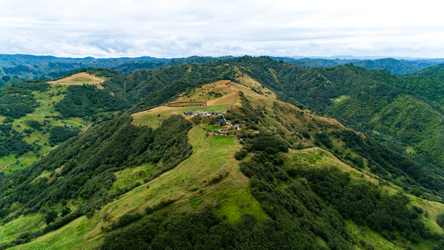 Aerial view of The Chef s Table at Blue Duck Station amidst rolling hills a vivid tapestry of green and brown under a dramatic sky Retaruke Manawatu Whanganui Region New Zealand. Aerial view of The Chef s Table at Blue Duck Station amidst rolling hills a vivid tapestry of green and brown under a dramatic sky Retaruke Manawatu Whanganui Region New Zealand.