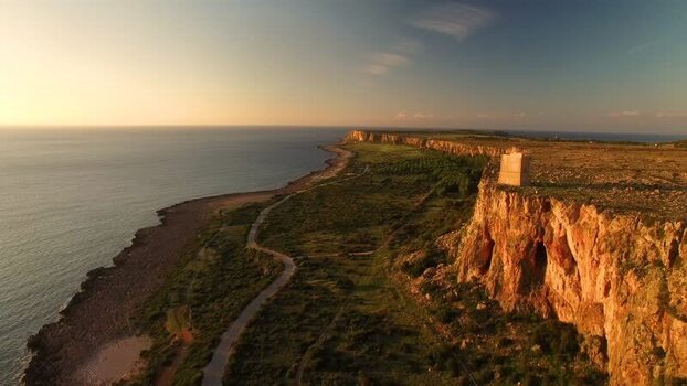 Aerial view of coastal watchtower on cliffs in Sicily Italy.