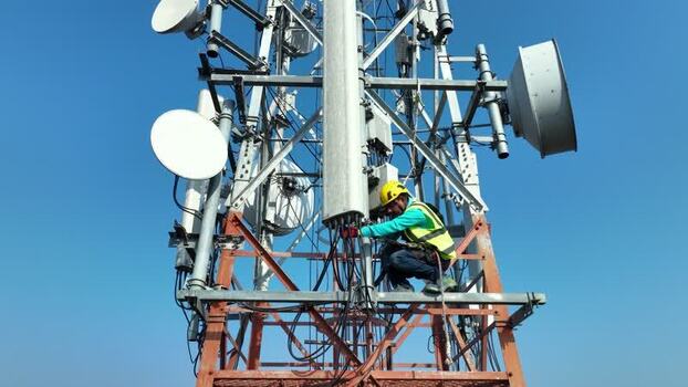 Aerial view of a technician working on a cell tower Bangladesh.