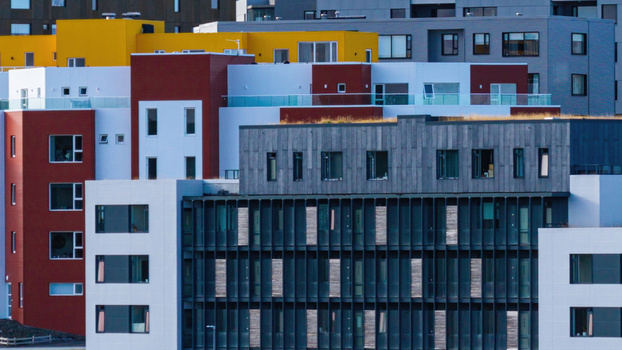 Aerial view of modern apartment complex with colorful facades and flat roofs in Iceland. Aerial view of modern apartment complex with colorful facades and flat roofs in Iceland.