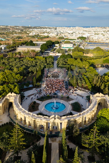Attard Northern Region Malta 20 September 2026 Aerial view of the Greek Theatre at Park Nazzjonali Ta Qali with a fountain and a crowd gathered for an event. Attard Northern Region Malta 20 September 2026 Aerial view of the Greek Theatre at Park Nazzjonali Ta Qali with a fountain and a crowd gathered for an event.
