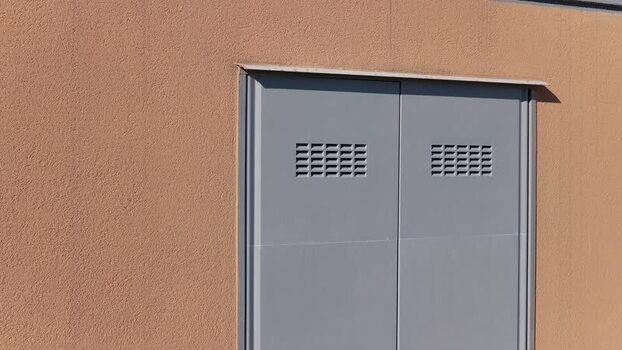 Aerial view of a grey metal utility door in Faenza Italy.