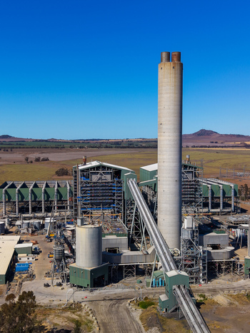Aerial view of Millmerran Power Station featuring a tall chimney and industrial conveyor belt infrastructure set in the rural landscape of Domville Queensland Australia. Aerial view of Millmerran Power Station featuring a tall chimney and industrial conveyor belt infrastructure set in the rural landscape of Domville Queensland Australia.
