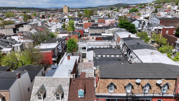 Aerial view of the dense residential neighborhood with rows of houses varied rooftops and lush green trees in Reading Pennsylvania United States. Aerial view of the dense residential neighborhood with rows of houses varied rooftops and lush green trees in Reading Pennsylvania United States.