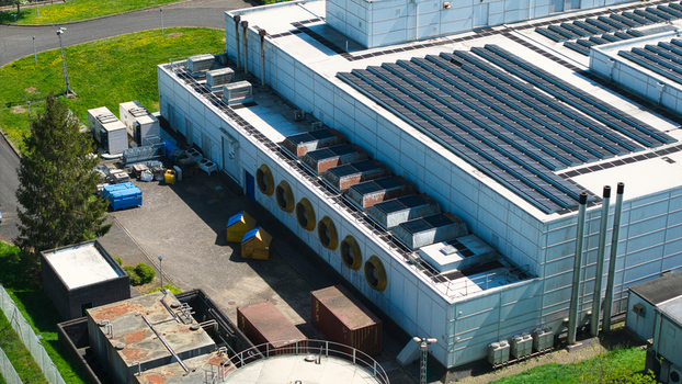 Aerial view of a data centre featuring solar panels on the roof industrial cooling systems and ventilation fans Wellingborough England United Kingdom. Aerial view of a data centre featuring solar panels on the roof industrial cooling systems and ventilation fans Wellingborough England United Kingdom.