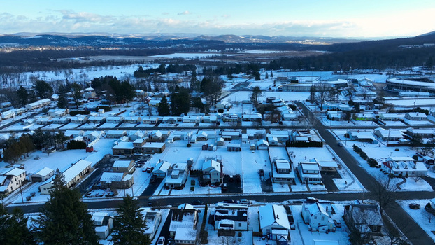 Aerial view of a snow covered residential neighborhood with houses streets and trees in Williamsport Pennsylvania United States.