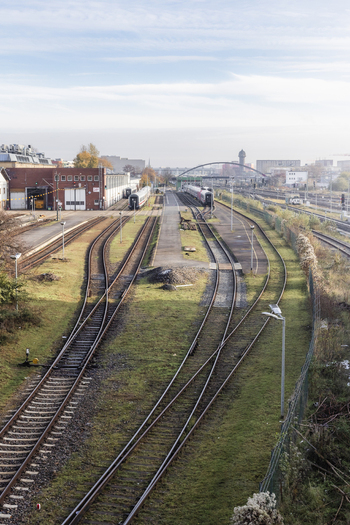 Berlin Germany 23 November 2022 View of railway tracks and train yard with industrial buildings and a distant bridge under a clear sky. Berlin Germany 23 November 2022 View of railway tracks and train yard with industrial buildings and a distant bridge under a clear sky.