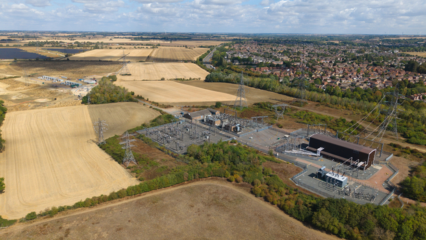 Aerial view of Eaton Socon Substation solar farm and battery energy storage systems surrounded by agricultural fields and the town of St. Neots England United Kingdom. Aerial view of Eaton Socon Substation solar farm and battery energy storage systems surrounded by agricultural fields and the town of St. Neots England United Kingdom.
