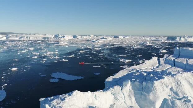 Aerial view of Ilulissat glacier and icebergs in Greenland.