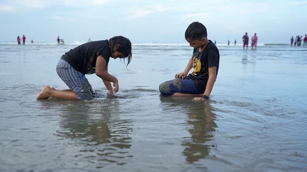 View of children playing on the beach at Cox s Bazar Bangladesh. View of children playing on the beach at Cox s Bazar Bangladesh.