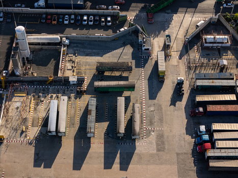 Aerial view of the beer industrial complex featuring rows of parked semi truck trailers storage tanks and logistics infrastructure in Santo Domingo Dominican Republic. Aerial view of the beer industrial complex featuring rows of parked semi truck trailers storage tanks and logistics infrastructure in Santo Domingo Dominican Republic.