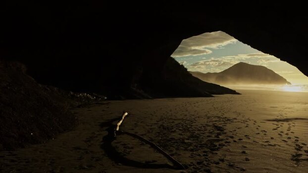 View of Wharariki Beach through a cave archway New Zealand. View of Wharariki Beach through a cave archway New Zealand.