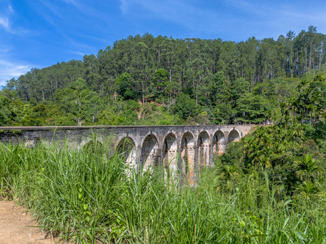 Aerial view of the historic Nine Arch Bridge surrounded by lush tropical forest and greenery in Demodara Uva Province Sri Lanka. Aerial view of the historic Nine Arch Bridge surrounded by lush tropical forest and greenery in Demodara Uva Province Sri Lanka.