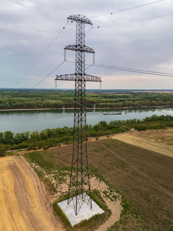 Aerial view of Danube power lines near Ercsi with farmland and boats below Aerial view of Danube power lines near Ercsi with farmland and boats below