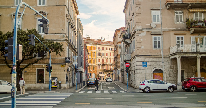 Rijeka Primorje Gorski Kotar Croatia 19 September 2026 View of a street intersection with historic buildings traffic lights a pedestrian crossing and parked cars. Rijeka Primorje Gorski Kotar Croatia 19 September 2026 View of a street intersection with historic buildings traffic lights a pedestrian crossing and parked cars.