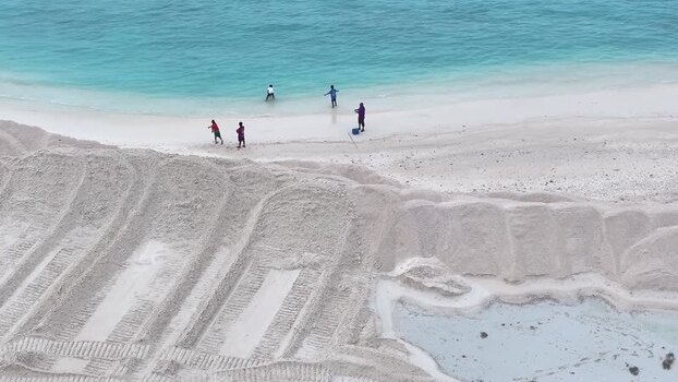 Aerial view of people on a reclaimed land with sand mounds in Gulhi Maldives.