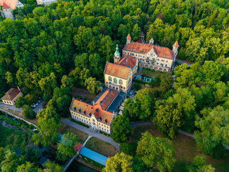 Aerial view of a historic building complex with red tiled roofs nestled within a lush forest in Rothenburg ob der Tauber Bavaria Germany. Aerial view of a historic building complex with red tiled roofs nestled within a lush forest in Rothenburg ob der Tauber Bavaria Germany.