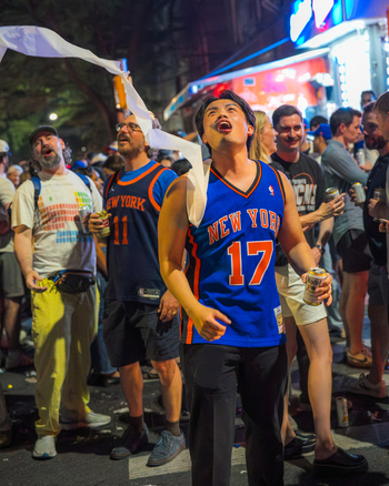 Williamsburg New York USA 14 June 2026 View of enthusiastic fans wearing New York Knicks jerseys celebrating in the streets during the NBA championship victory. Williamsburg New York USA 14 June 2026 View of enthusiastic fans wearing New York Knicks jerseys celebrating in the streets during the NBA championship victory.