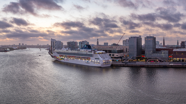 Hamburg Germany 23 April 2026 Aerial view of the Cruise Center HafenCity with a large cruise ship docked alongside modern architecture and the Elbe river under a cloudy sunset sky. Hamburg Germany 23 April 2026 Aerial view of the Cruise Center HafenCity with a large cruise ship docked alongside modern architecture and the Elbe river under a cloudy sunset sky.