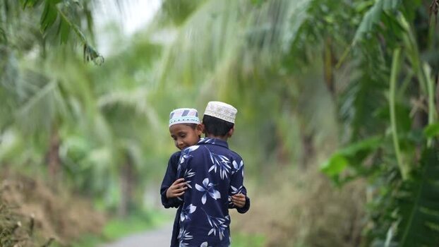 View of two young boys hugging on a path in Bogura Bangladesh. View of two young boys hugging on a path in Bogura Bangladesh.