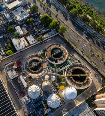 Aerial view of the beer industrial complex with large circular processing tanks and storage silos located near the coast in Santo Domingo Dominican Republic. Aerial view of the beer industrial complex with large circular processing tanks and storage silos located near the coast in Santo Domingo Dominican Republic.