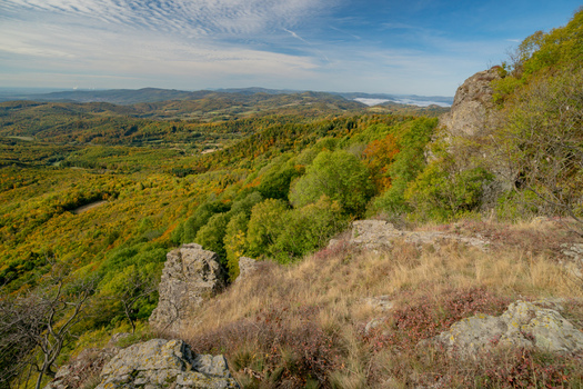 Aerial view of Sitno in Stiavnicke Vrchy with autumn foliage rocky outcrops and rolling hills in Ilija Banska Bystrica Regio Slovakia.