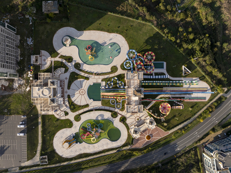 Aerial view of a water park featuring colorful water slides swimming pools and paved walkways surrounded by green lawns in Bulgaria. Aerial view of a water park featuring colorful water slides swimming pools and paved walkways surrounded by green lawns in Bulgaria.