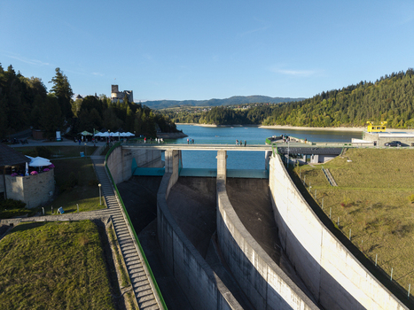 Aerial view of Niedzica Hydroelectric Power Plant and dam with Niedzica Castle in the background overlooking Czorsztyn Lake in Niedzica Malopolskie Voivodeship Poland. Aerial view of Niedzica Hydroelectric Power Plant and dam with Niedzica Castle in the background overlooking Czorsztyn Lake in Niedzica Malopolskie Voivodeship Poland.