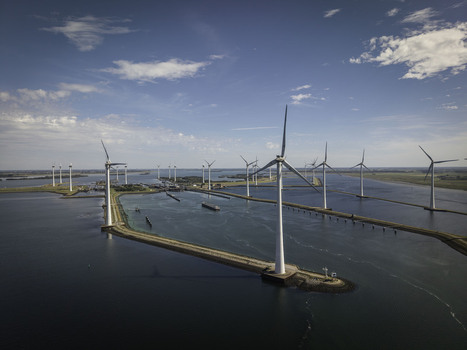Aerial view of the Grevelingendam wind farm with rows of white turbines standing in the water under a clear blue sky in Bruinisse Zeeland Netherlands. Aerial view of the Grevelingendam wind farm with rows of white turbines standing in the water under a clear blue sky in Bruinisse Zeeland Netherlands.